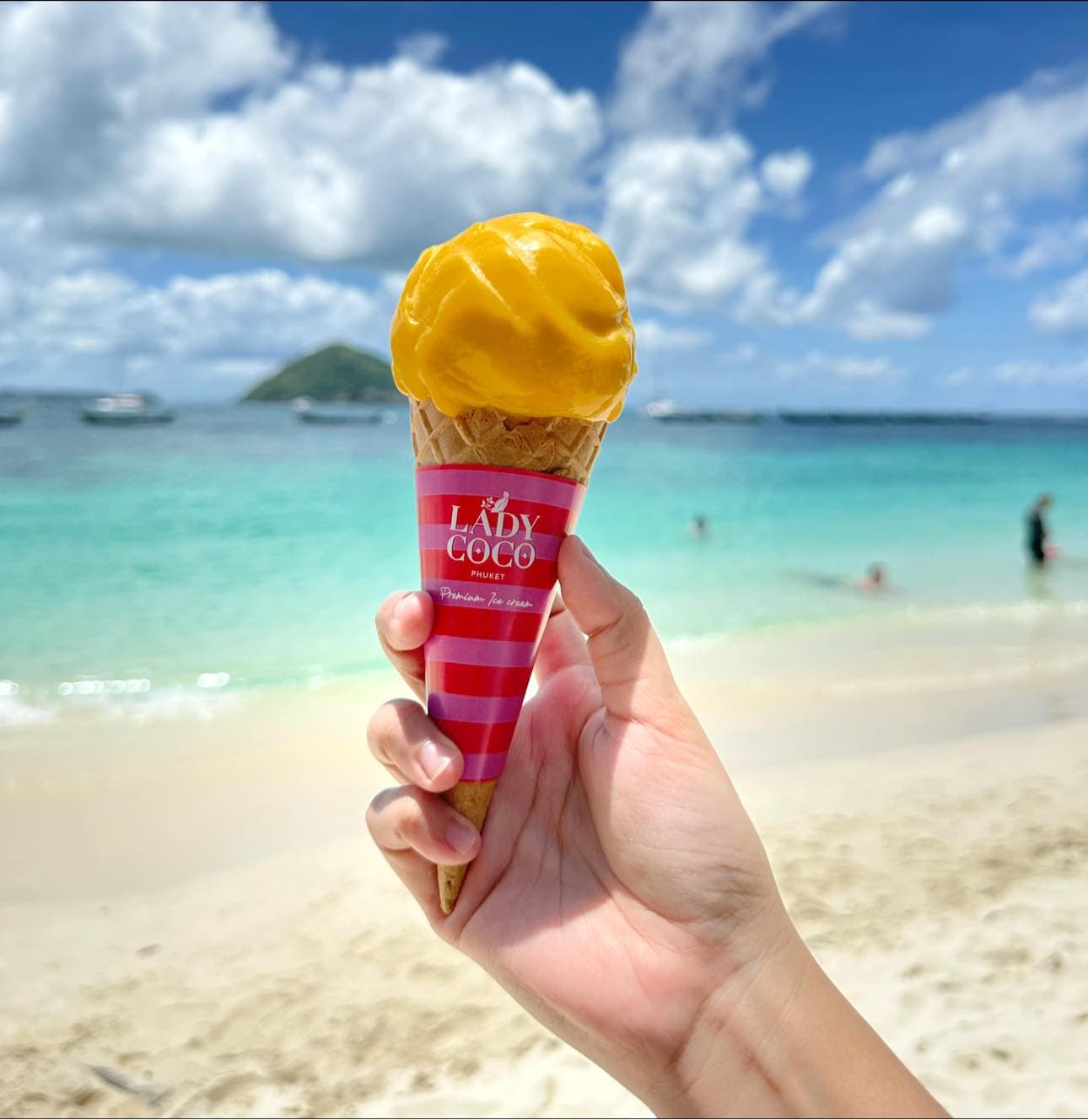 A real Lady Coco mango ice cream cone by the turquoise sea in Phuket